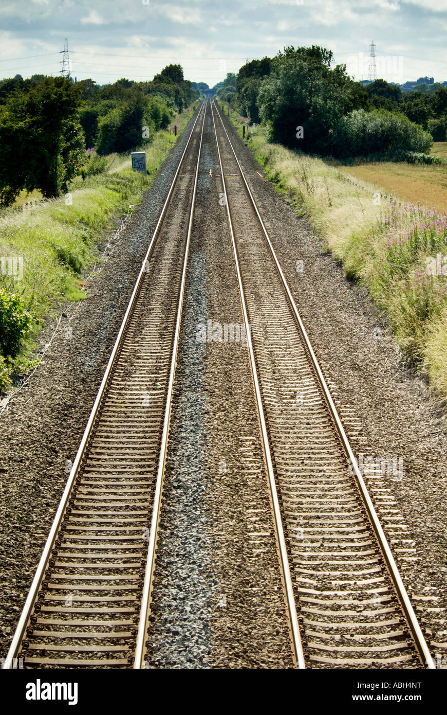 Converging railway lines disappear into the distance Stock Photo