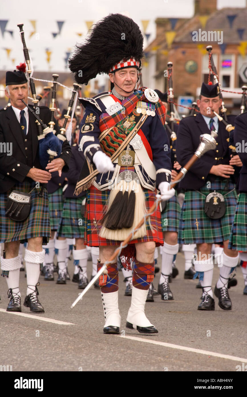 Scottish traditional music pipe major with pipe band marching down