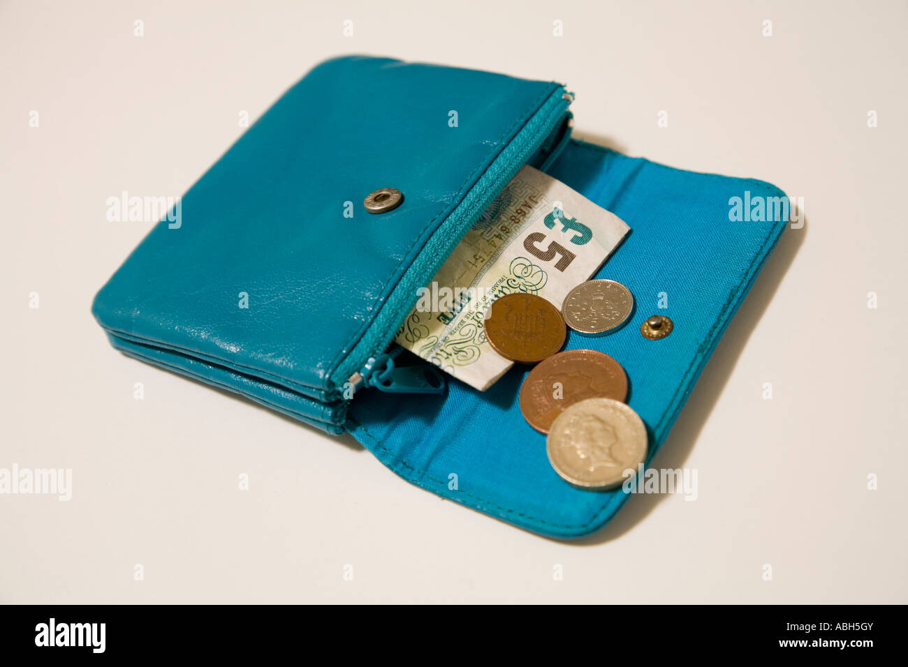 blue leather purse, five pound note, and small change Stock Photo