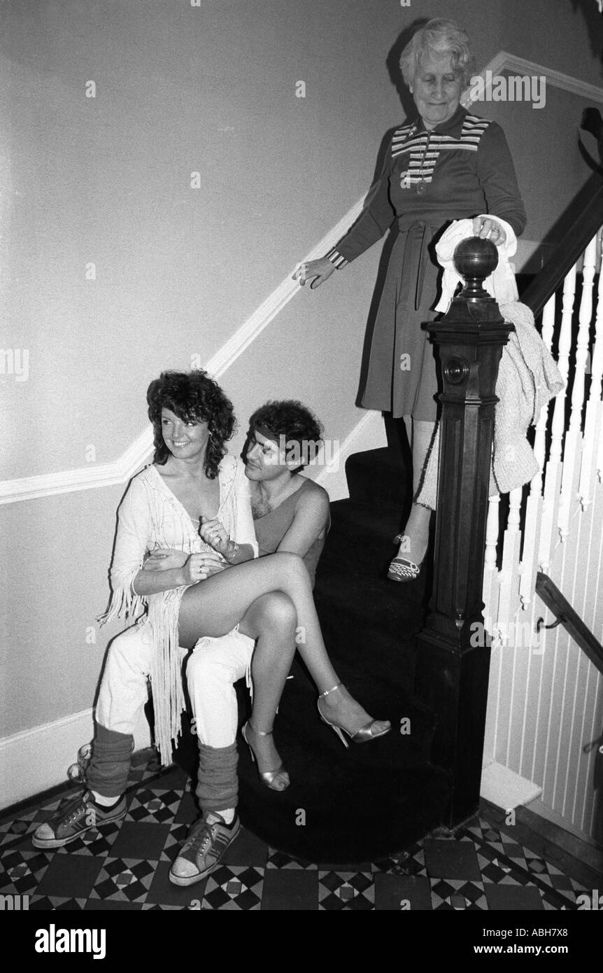 Suburban middle class fancy dress party. Couple on steps, Grandmother coming down stairs. Wimbledon London SW19 England 1983. 1980s Uk HOMER SYKES Stock Photo