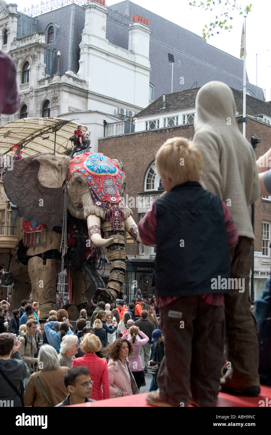 Street  theatre by Royal De Luxe. Young boys watching The Sultan's Elephant. St James's, London, England Stock Photo
