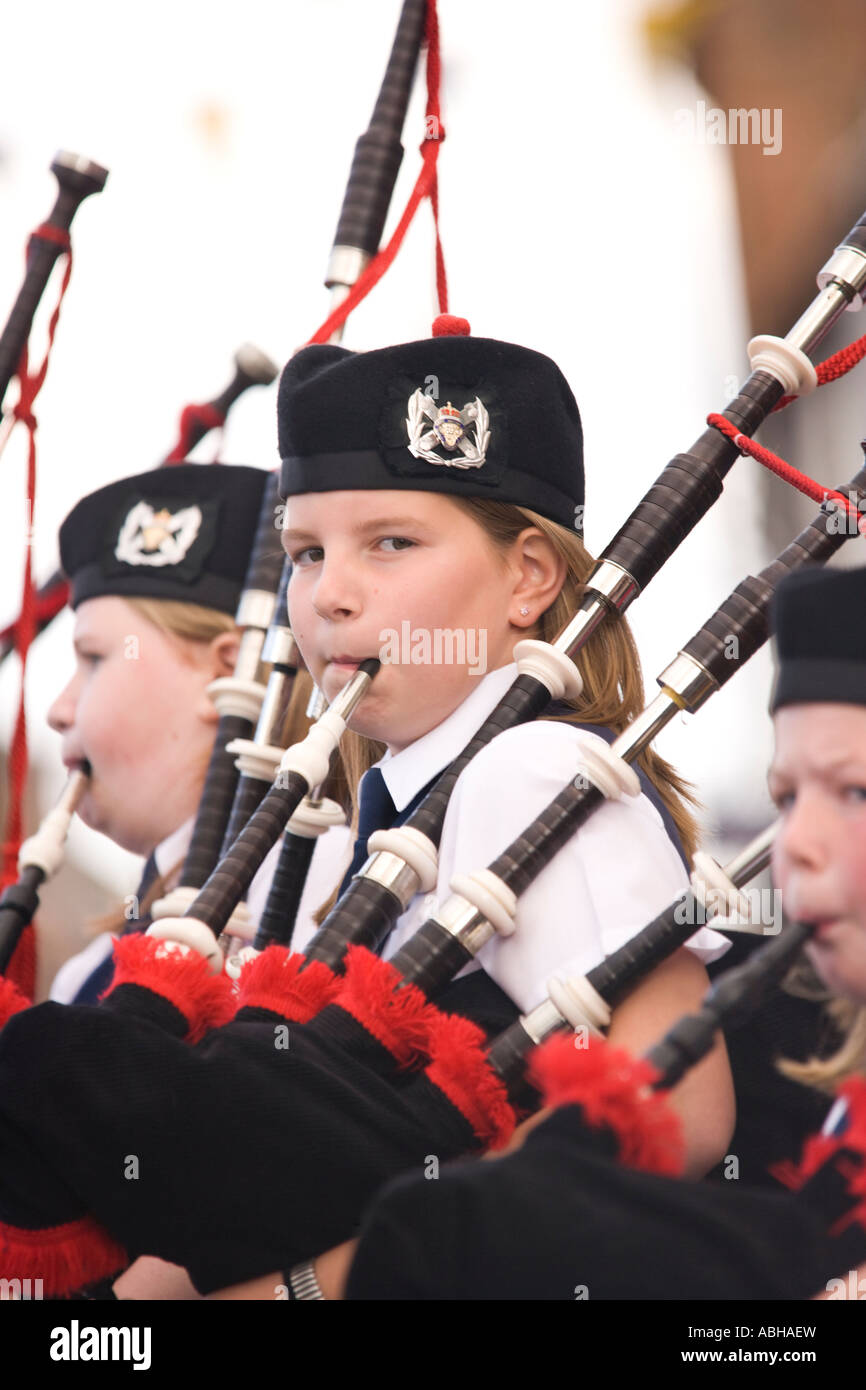 Pipe band young girl playing the bagpipes on Annan High Street part of the Annan Riding of the Marches Scotland UK Stock Photo