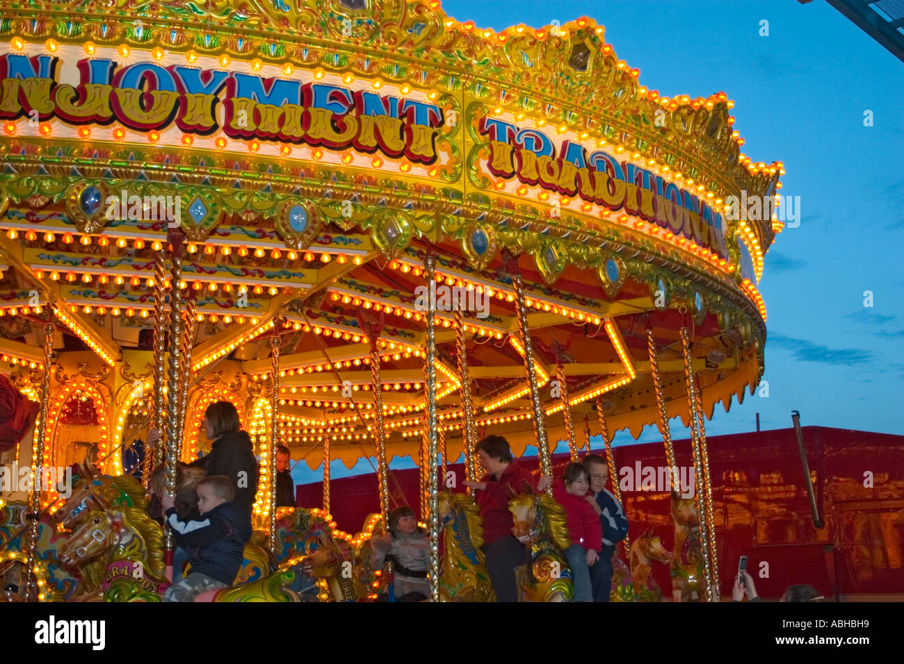 Illuminated carousel fairground ride Stock Photo