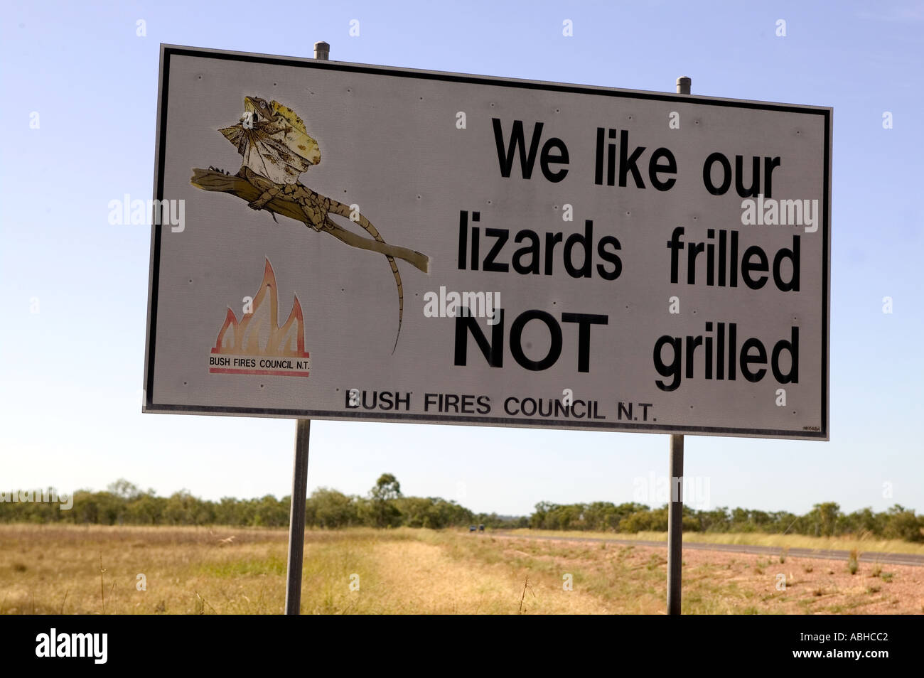 Sign urging locals to prevent bush fires which kill frill neck lizards in Northern Territory Australia Stock Photo