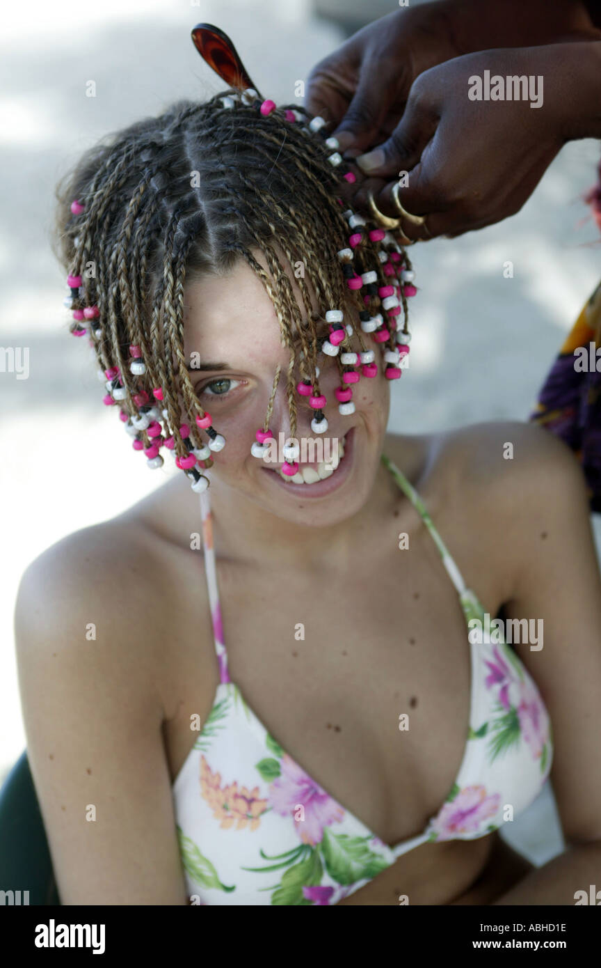 Holidaymaker Having Her Hair Braided On A Beach On New Providence Stock Photo Alamy