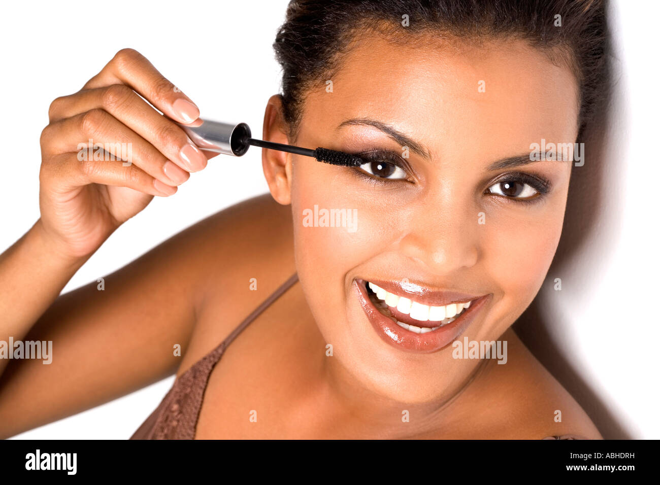Portrait of a smiling woman applying mascara Stock Photo Alamy