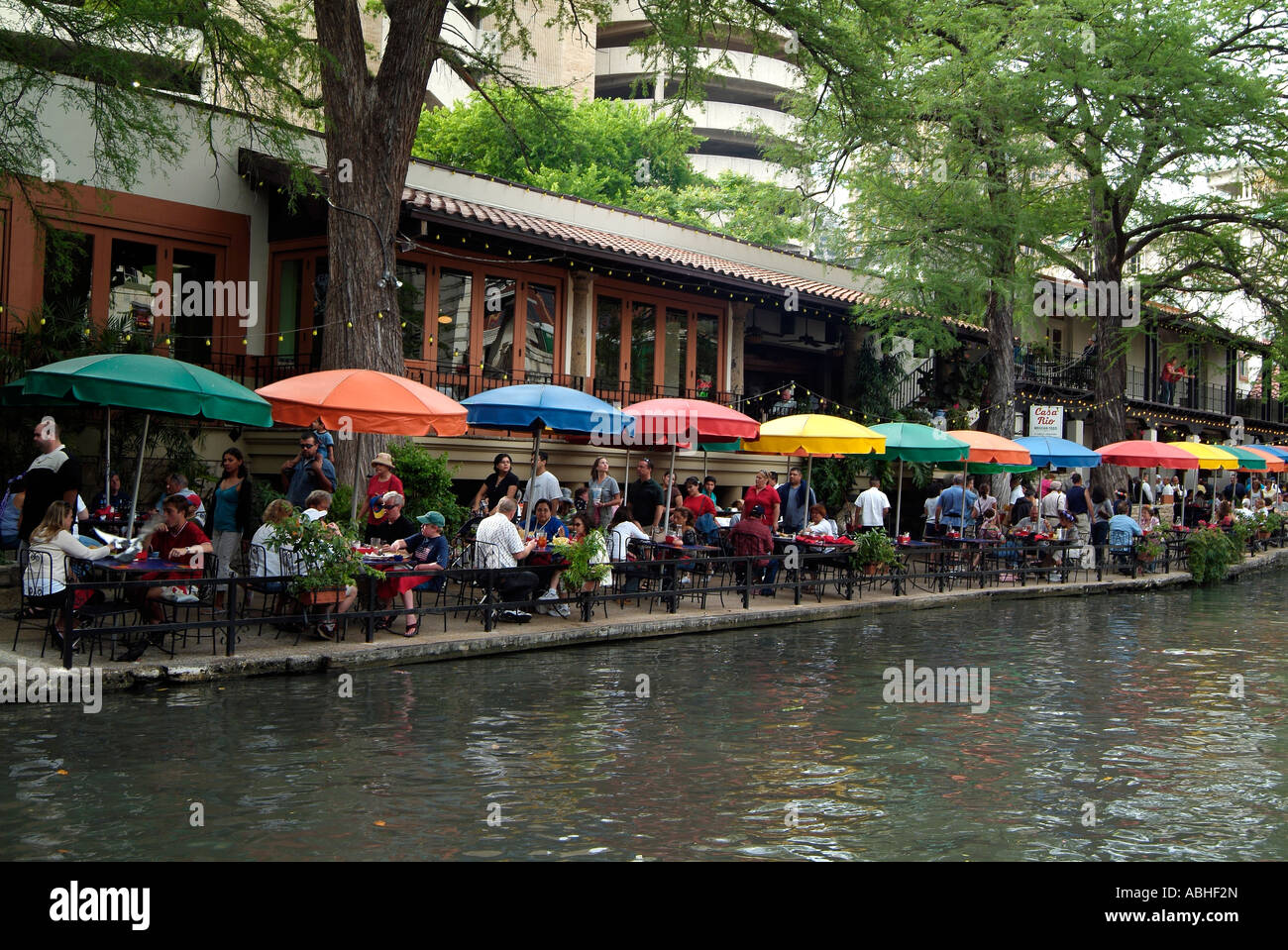 People eating at a restaurant on the riverwalk in San Antonio. Stock Photo