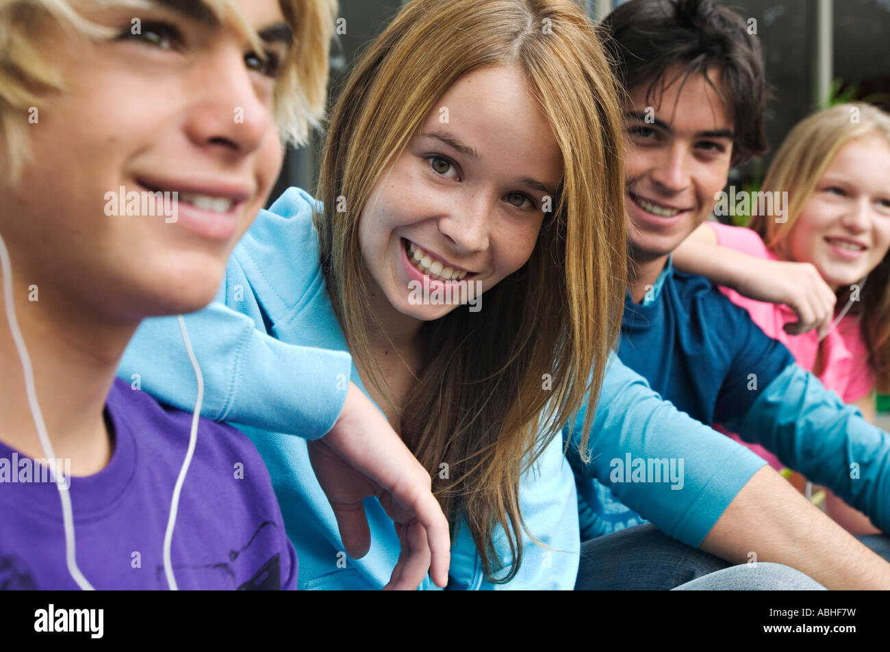 2 teenage boys and 2 teenage girls smiling for camera Stock Photo - Alamy