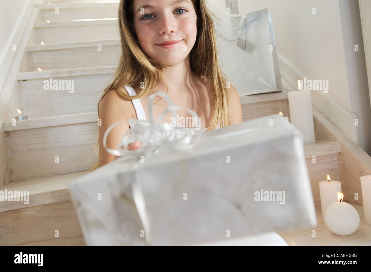 Little girl holding a Christmas present, indoors Stock Photo - Alamy