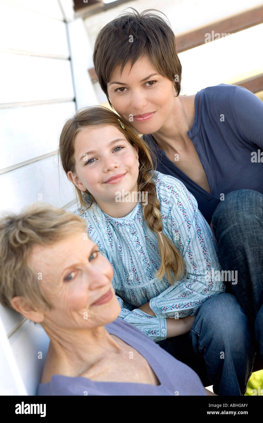 Female members of three generation family looking at camera, outdoors Stock Photo