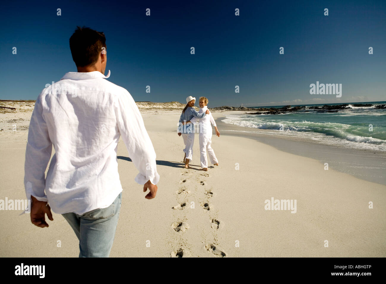 Couple and senior woman walking on beach Stock Photo - Alamy