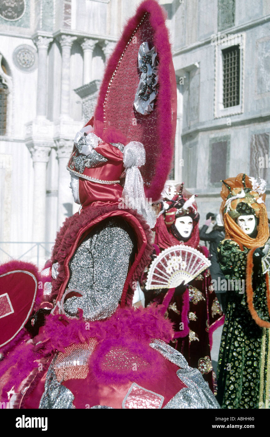 Three carnivalgoers with masks and costumes in Venice Italy Stock Photo ...