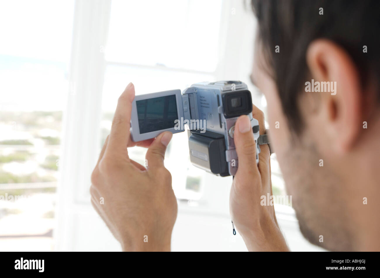 Young man using camcorder Stock Photo Alamy