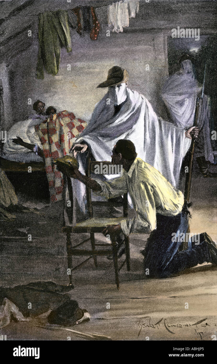 Ku Klux Klan men wrapped like ghosts in sheets on a murderous raid in a black family cabin 1800s. Hand-colored halftone of an illustration Stock Photo