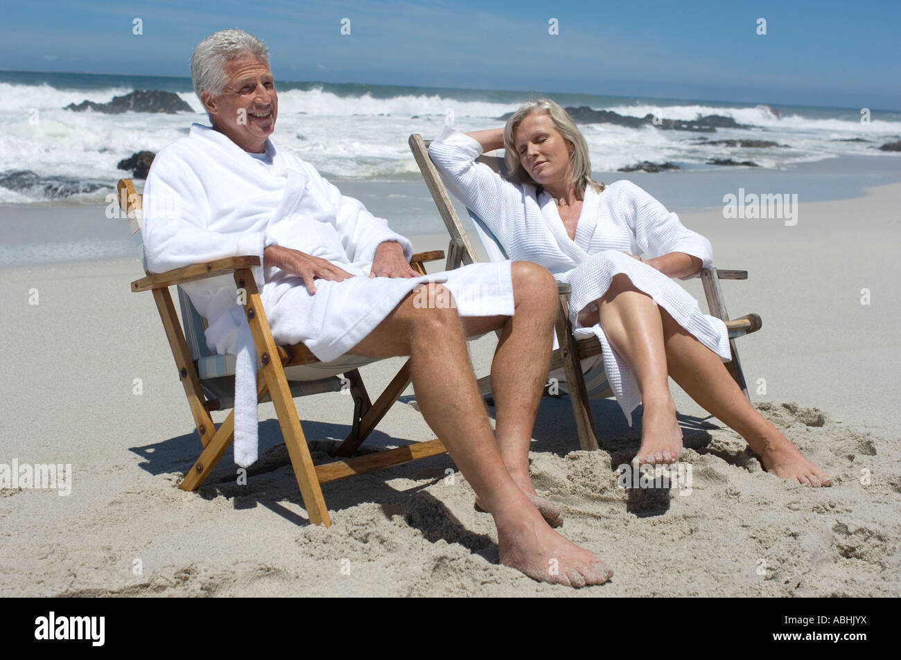 Couple in bathrobe, sitting on beach chairs Stock Photo - Alamy