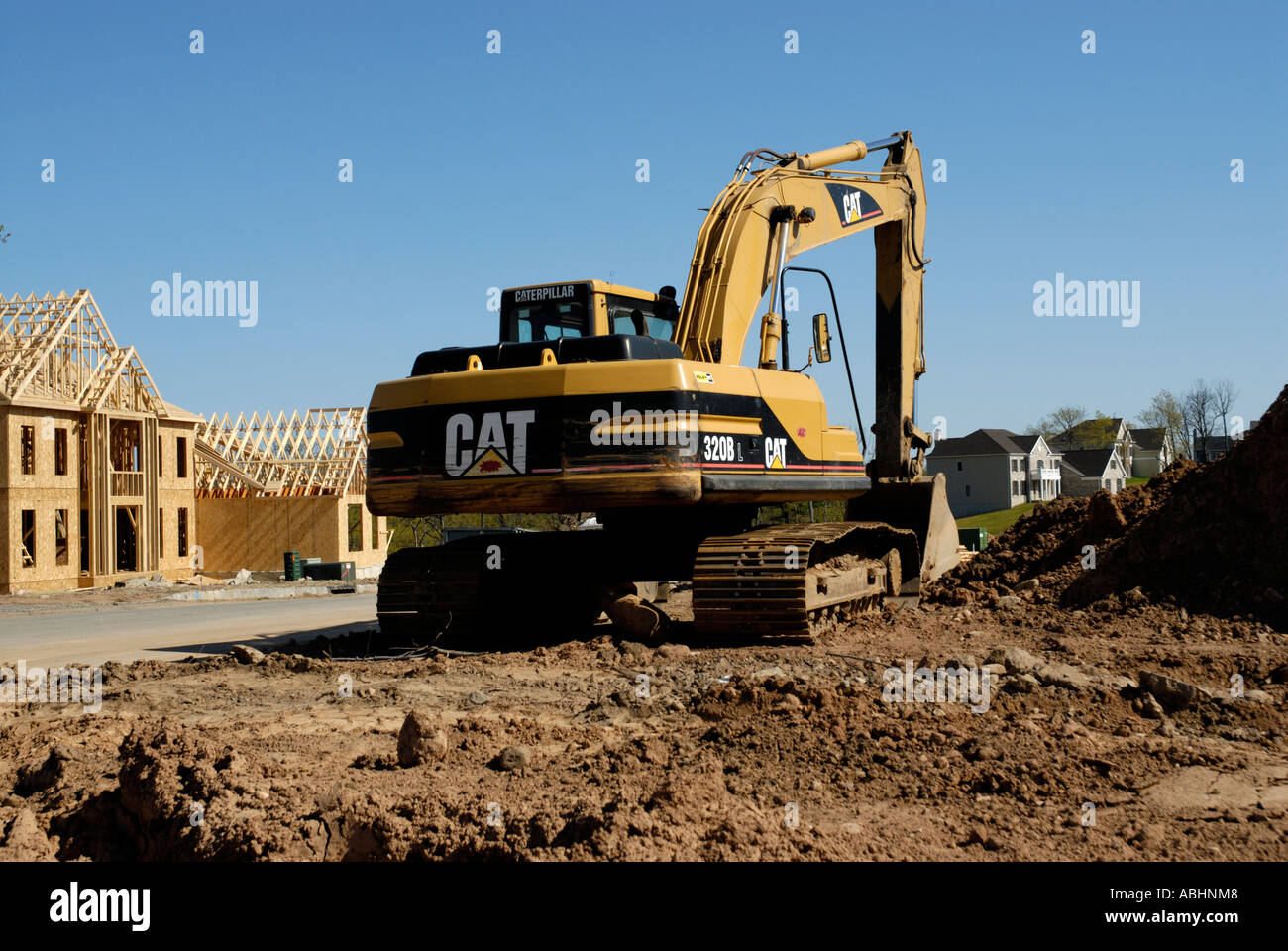 Excavator power shovel in suburban development Stock Photo - Alamy