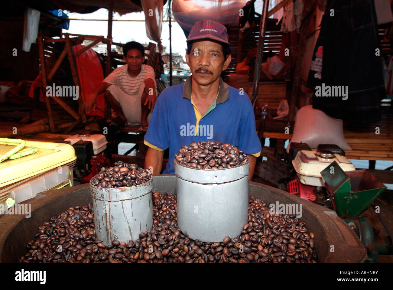 Man selling coffee beans in a market in Manado, North Sulawesi Stock