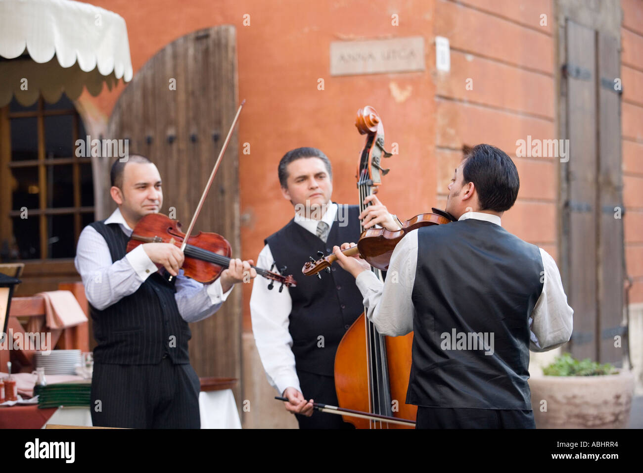 Three Musicians in front of a restautrant on Castle Hill Buda Budapest Hungary Stock Photo