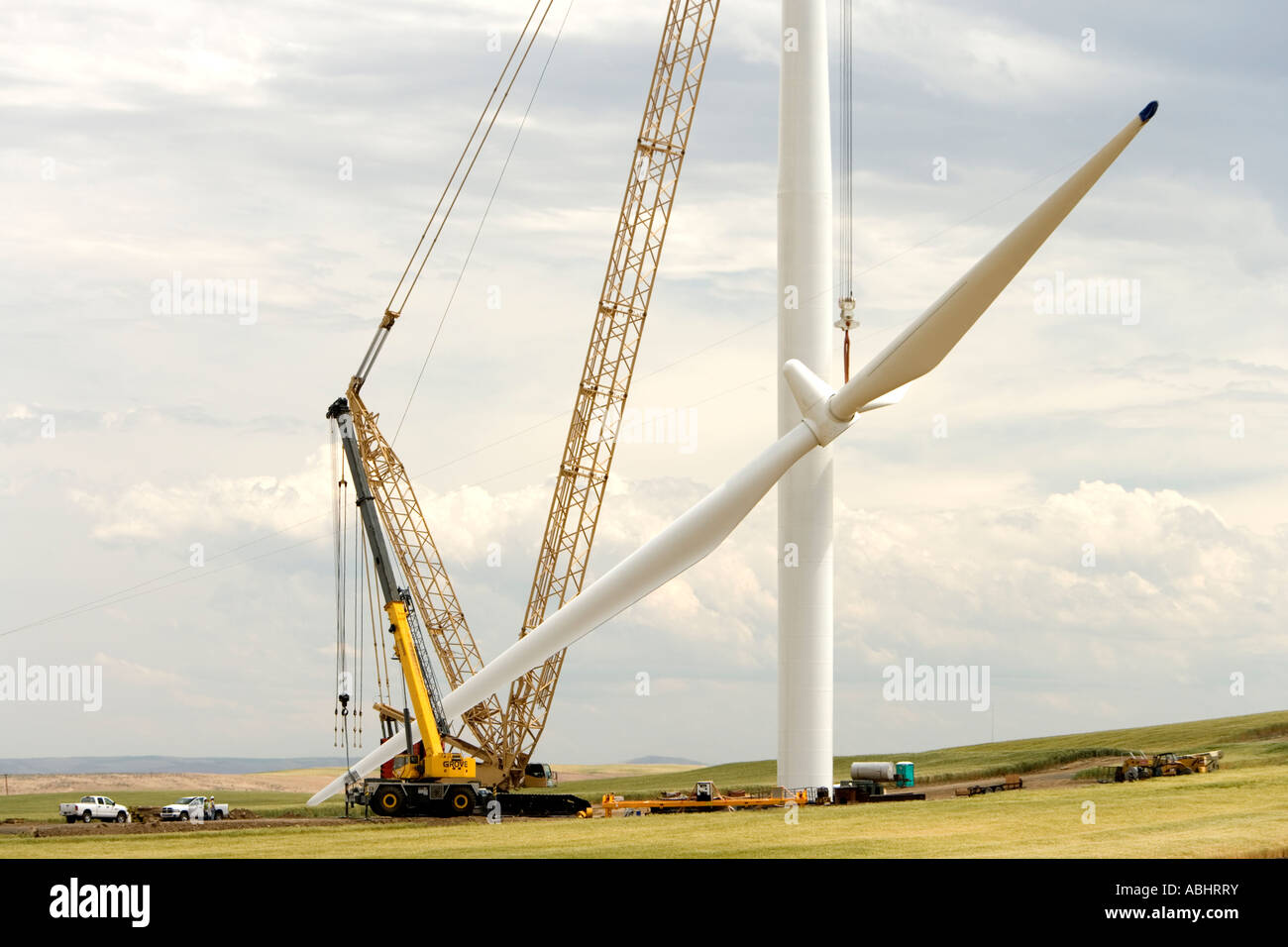Wind Turbine construction, crane raising propeller to be attached to generator. Stock Photo