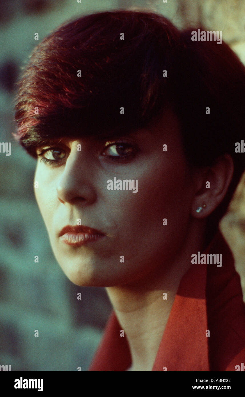 Close Up Of A Young Woman With Short Dark Red Streaked Hair And A