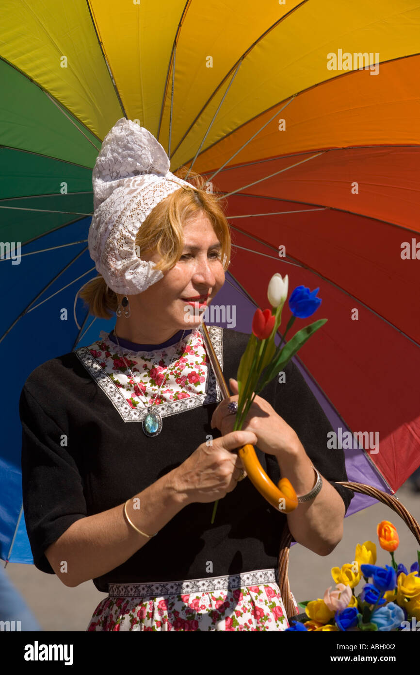 Woman in traditional dress selling tulips on Dam Amsterdam Holland Netherlands Stock Photo