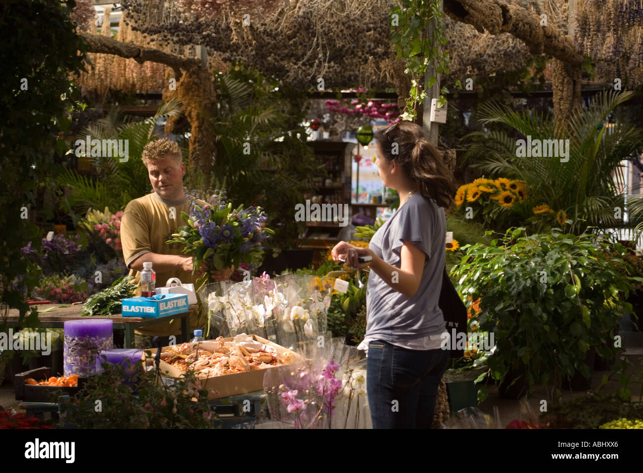 Woman buying a fresh bunch of flowers Bloemenmarkt Flower market Singel