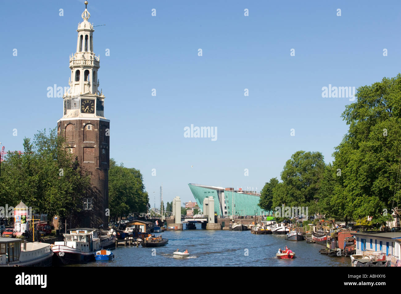 View over Oude Schans with leisure boats to Montelbaanstoren watch tower and NEMO Museum Amsterdam Holland Netherlands Stock Photo