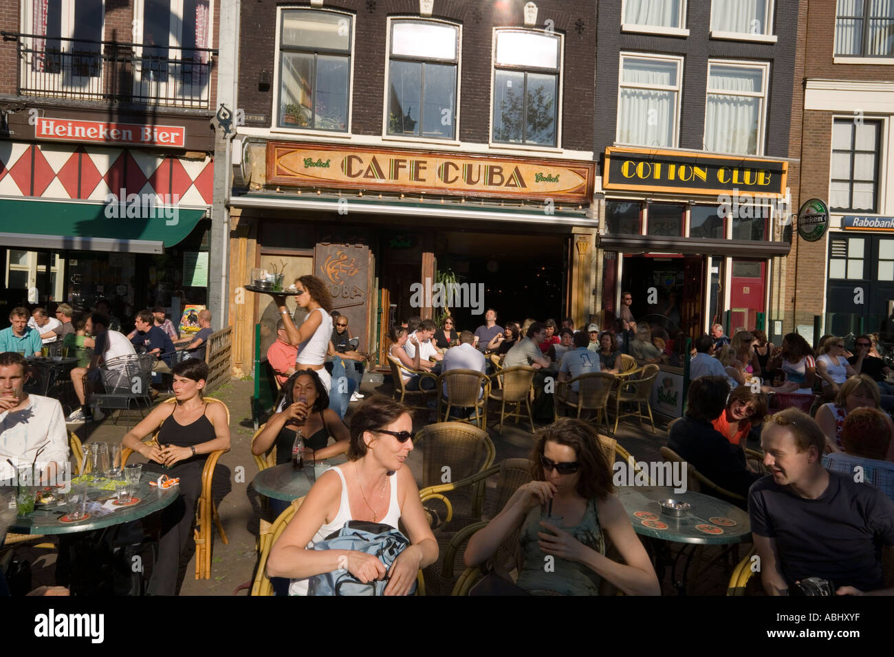 People sitting in open air cafes Nieuwmarkt new market Amsterdam Holland Netherlands Stock Photo
