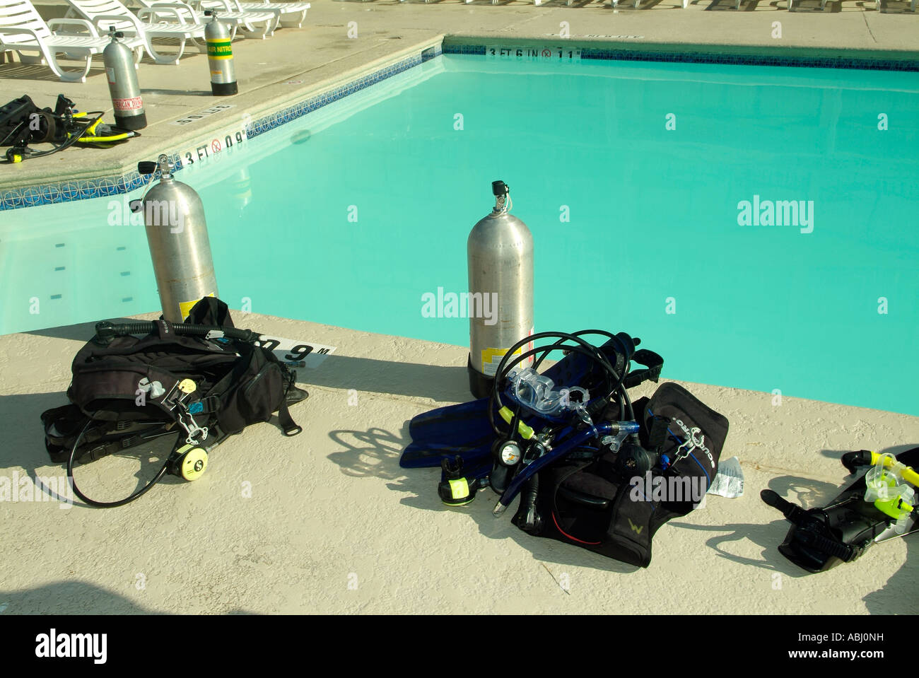 Aluminum tanks and buoyancy control devices (BCD) around a pool Stock Photo  - Alamy