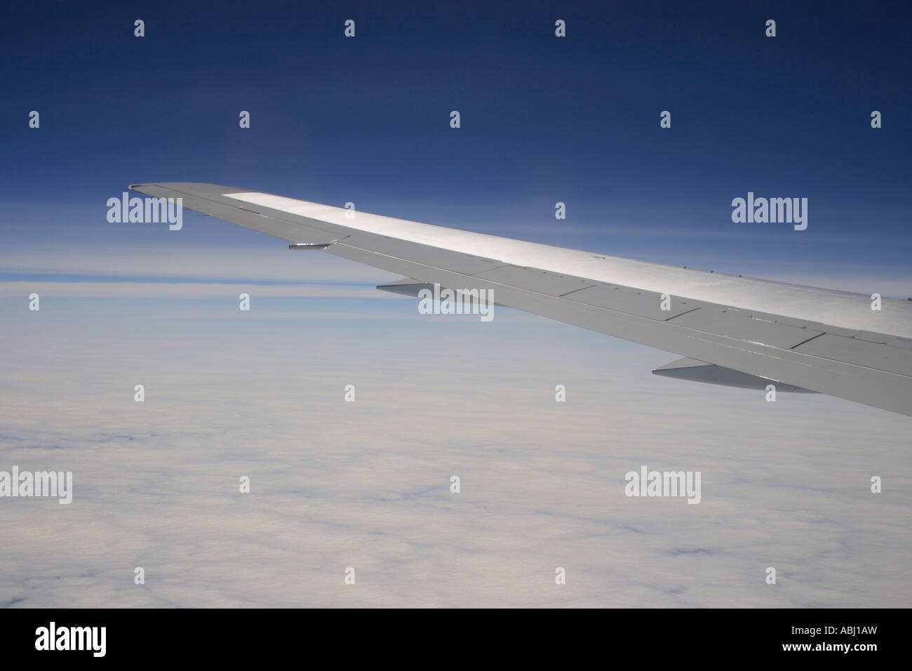 Wing and clouds in flight on an aircraft. Photo by Willy Matheisl Stock Photo