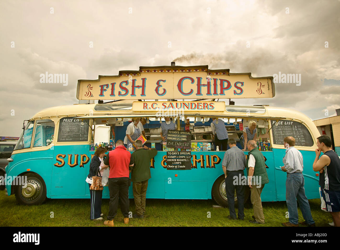Old fashioned fifties fish and chip van serving queue of customers at