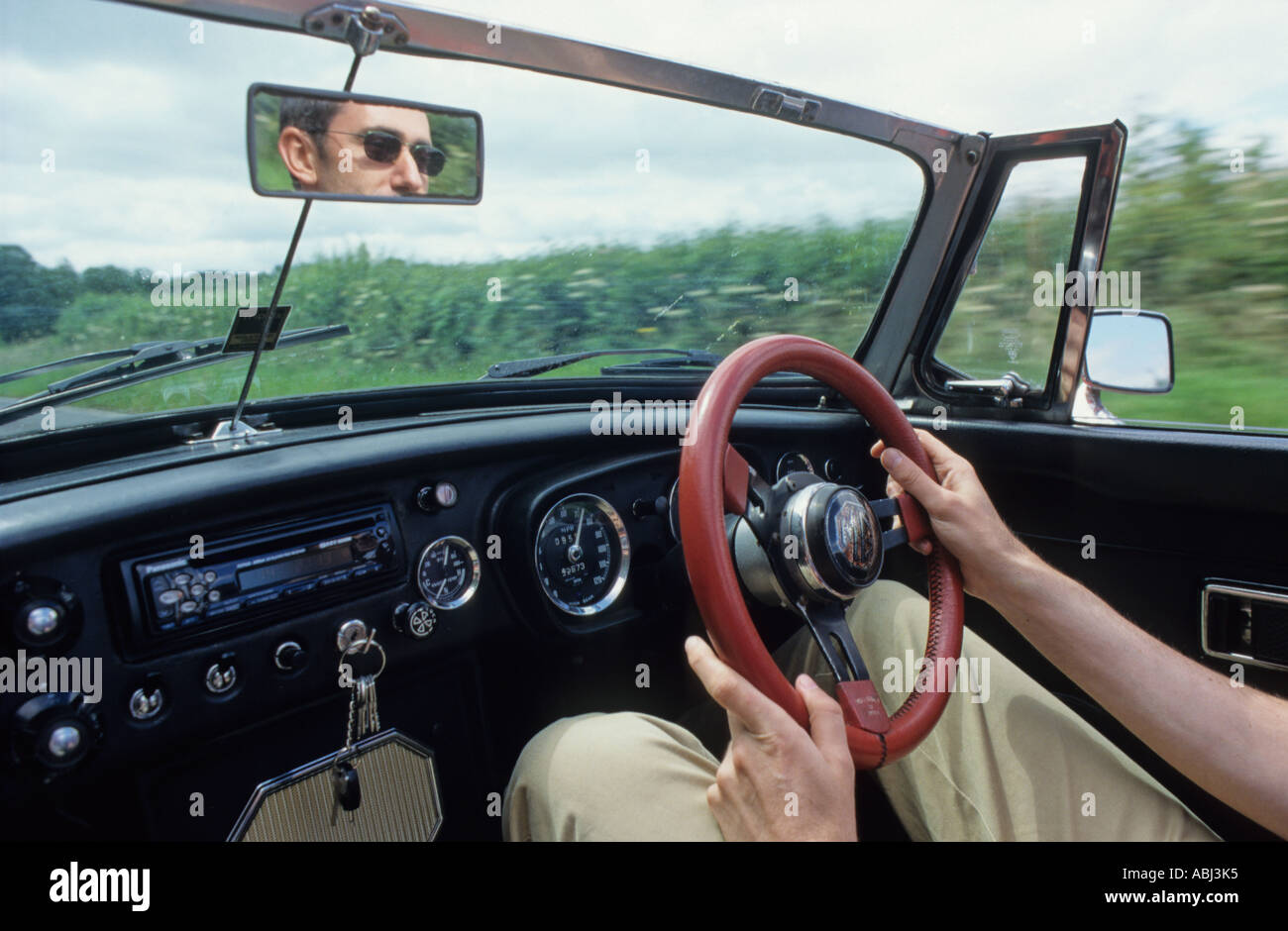 Driving an MGB roadster with the top down Stock Photo