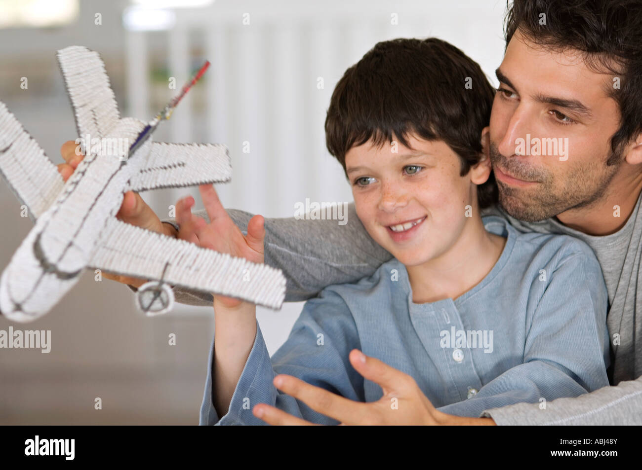 Father and son playing with model aeroplane Stock Photo - Alamy