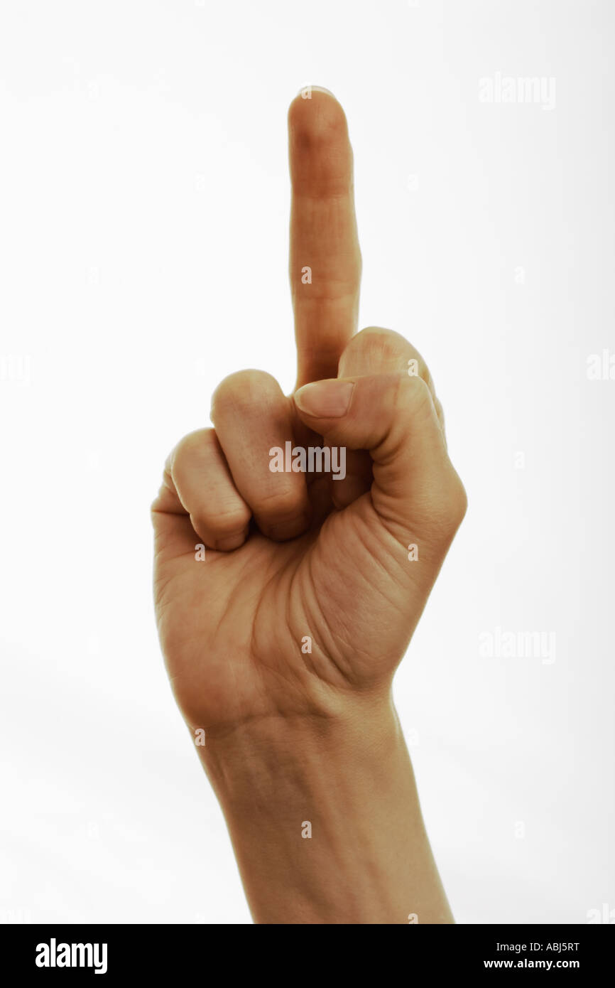 Woman giving obscene hand gesture with middle finger raised white background close up Stock Photo