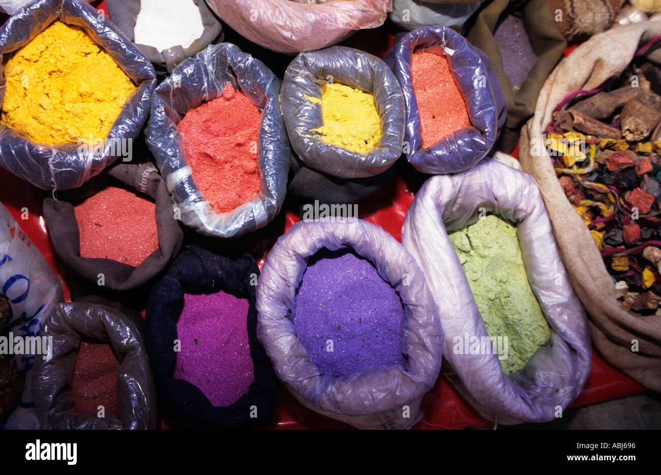 Pisac, Peru. Bags of powdered dyes on sale at the market; used for traditional woven fabrics. Stock Photo