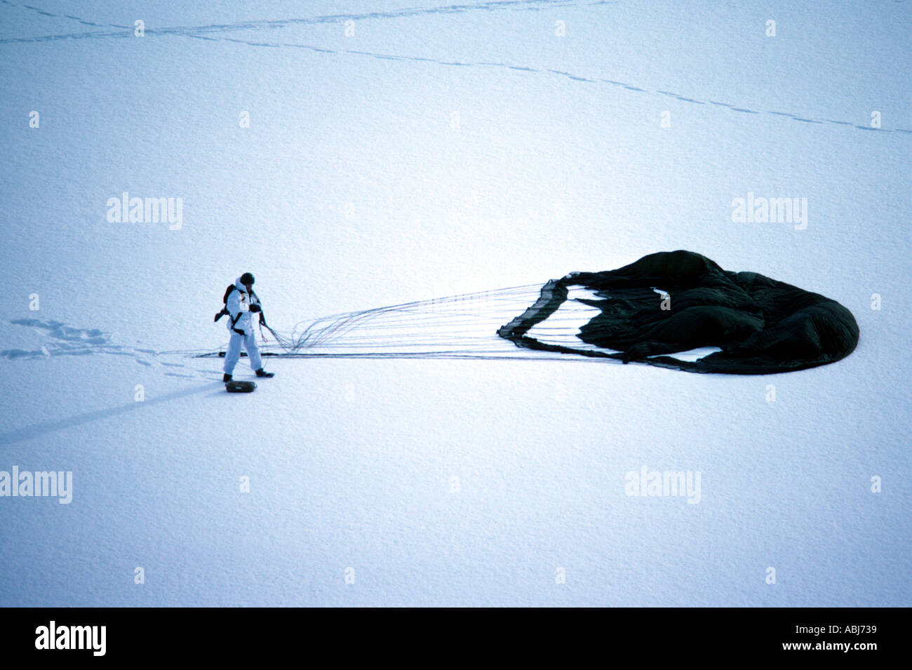 Mountain and Arctic Warfare in snow and ice with soldier and parachute Stock Photo