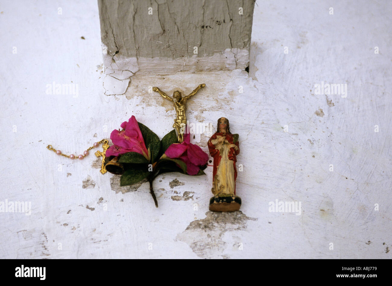 Sao Paulo, Brazil. Typical religious display on a white wall (cross, Jesus, flowers). Stock Photo