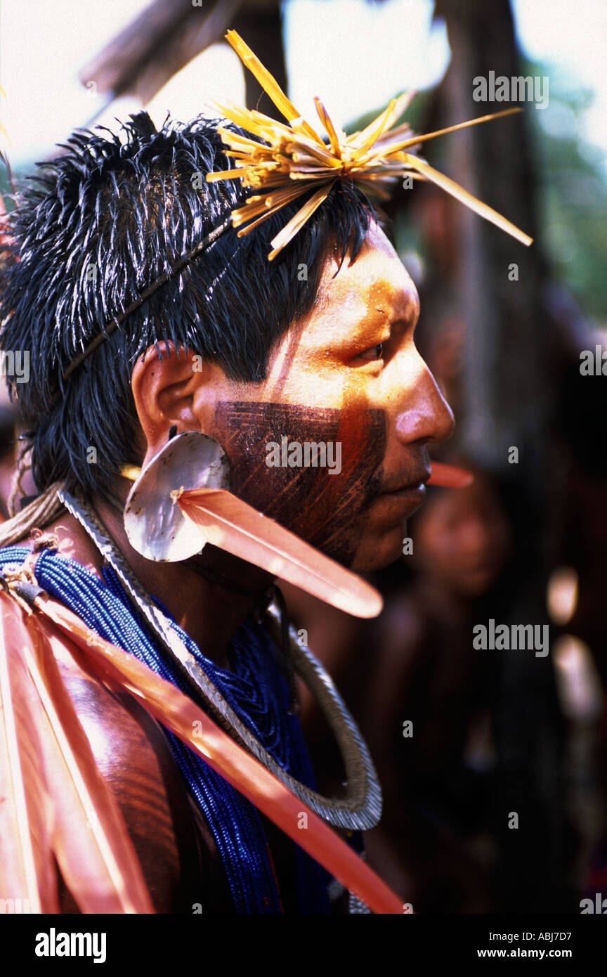 Bacaja village, Brazil. Xicrin Kayapo man with shell and feather ear decorations, bead necklaces and face paint. Stock Photo