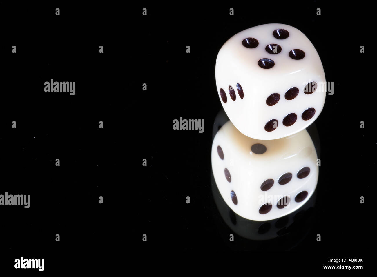 Dice on a mirror black background Stock Photo Alamy