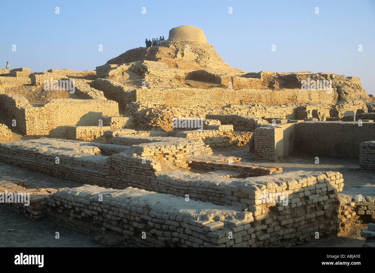 Broad view of  the ancient Indus Valley city of Mohenjodaro with the much later Buddhist stupa on the horizon. Stock Photo