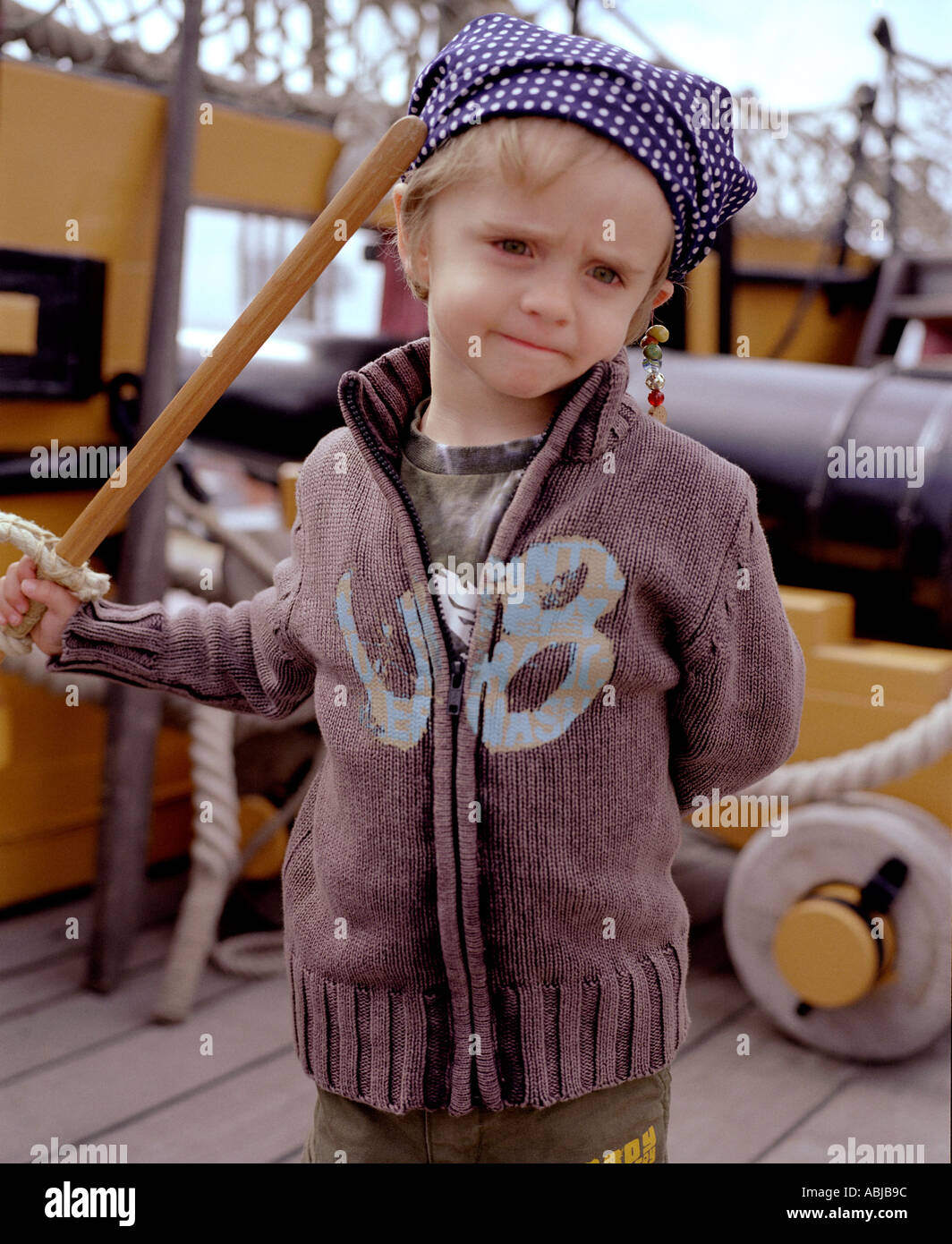 boy child dressed in fancy dress aspirate on  ship canon navy sword Stock Photo