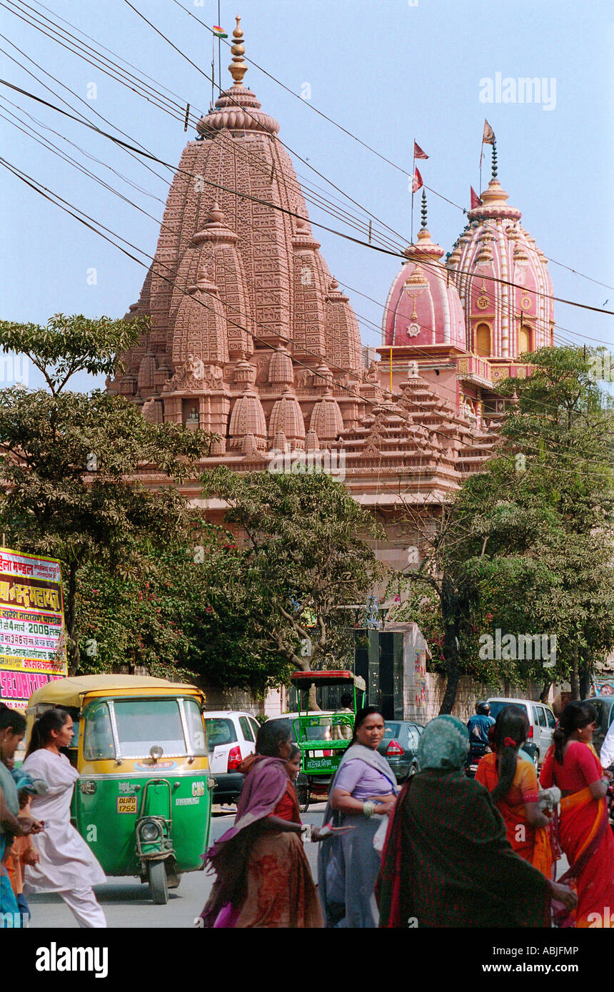 Hindu temple in Delhi, India, with women in saris and an auto rickshaw Stock Photo