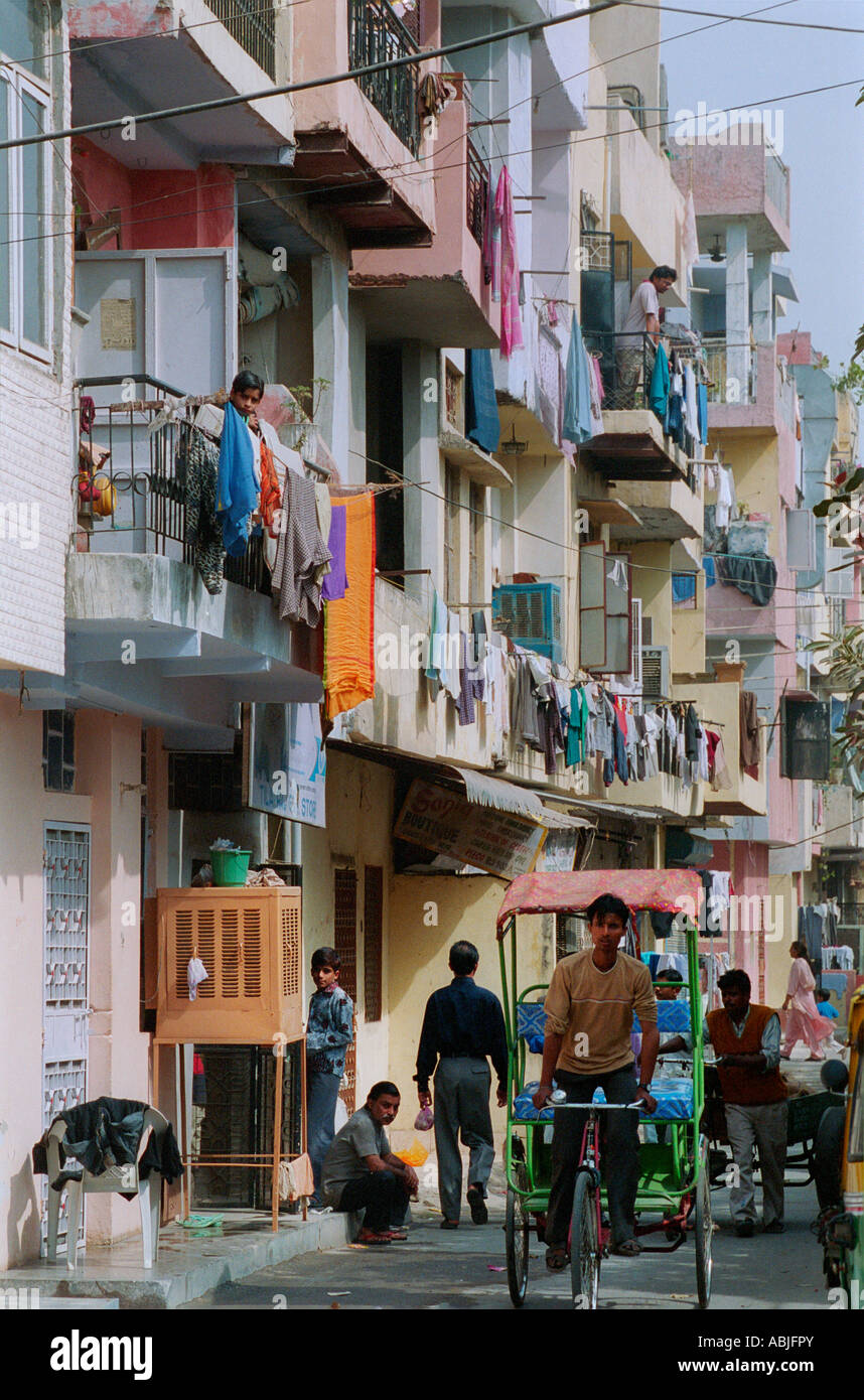 Apartment building in Delhi with washing hanging out to dry and cycle rickshaw Stock Photo