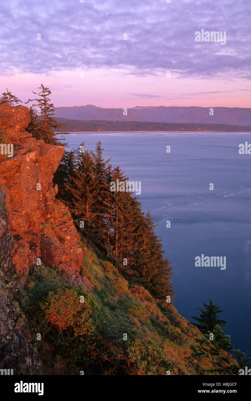 Sunset colors the rocky point of Cape Lookout State Park Oregon USA Stock Photo