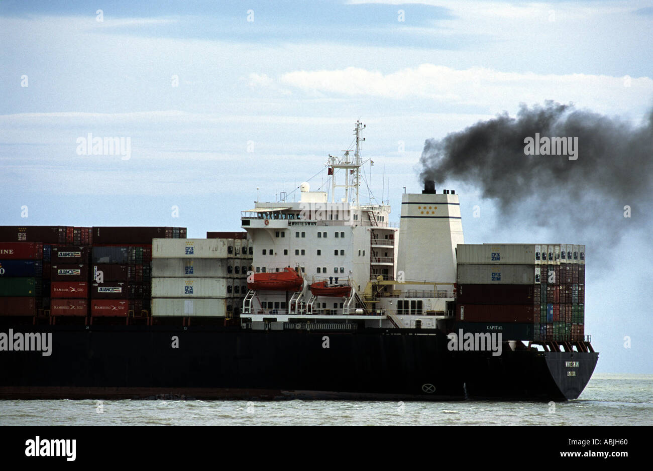 Container ship White Swan leaving the port of Felixstowe, Suffolk, UK. Stock Photo