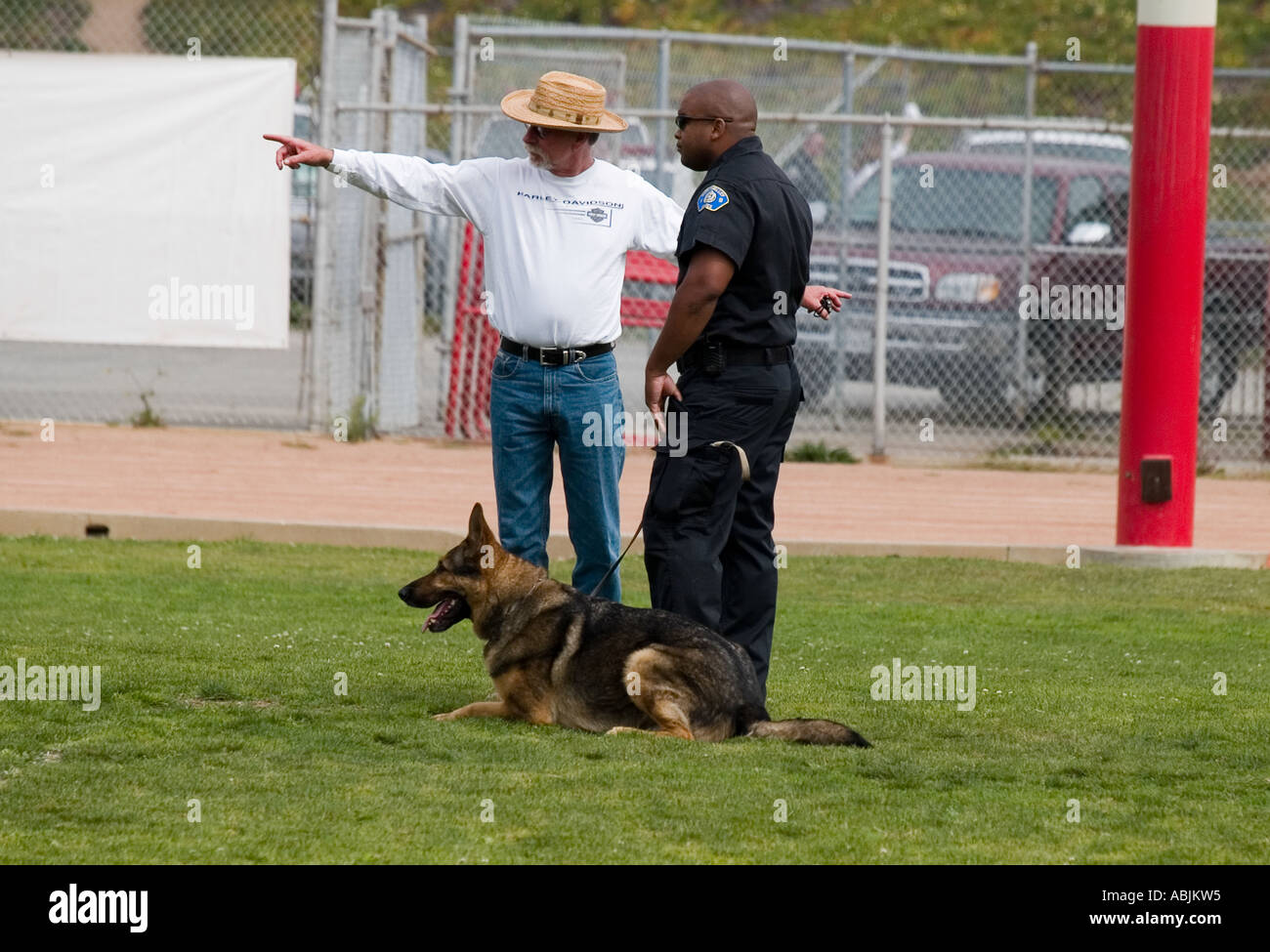 Redondo Beach CA K9 Trails 2006 Contest supervisor explains rules to dog handler in the area search competition. USA Stock Photo