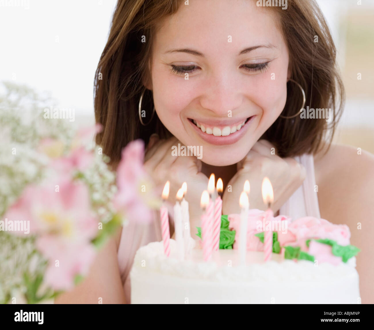 Woman smiling at birthday cake Stock Photo - Alamy