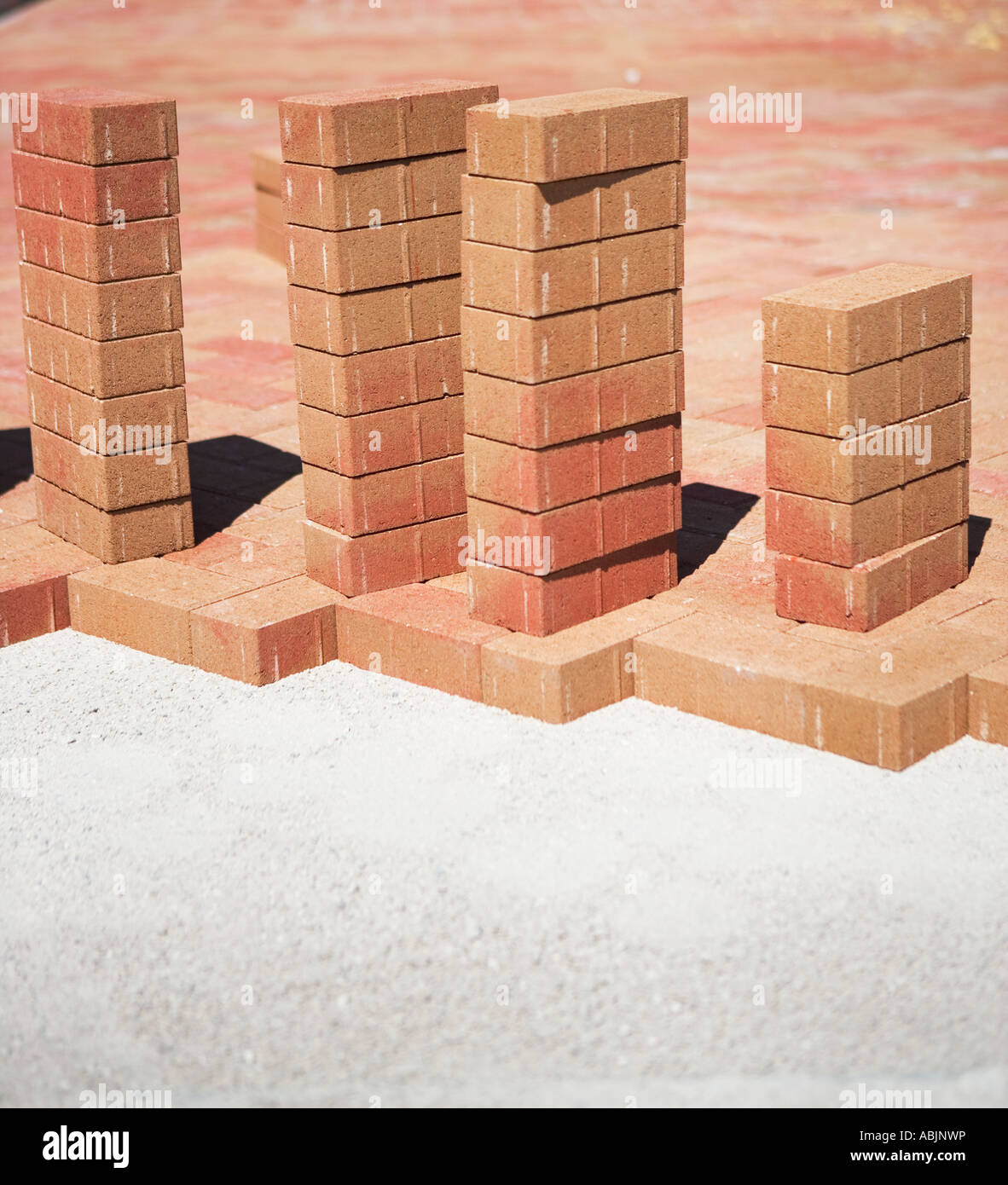Stacks of bricks on edge of new patio Stock Photo Alamy