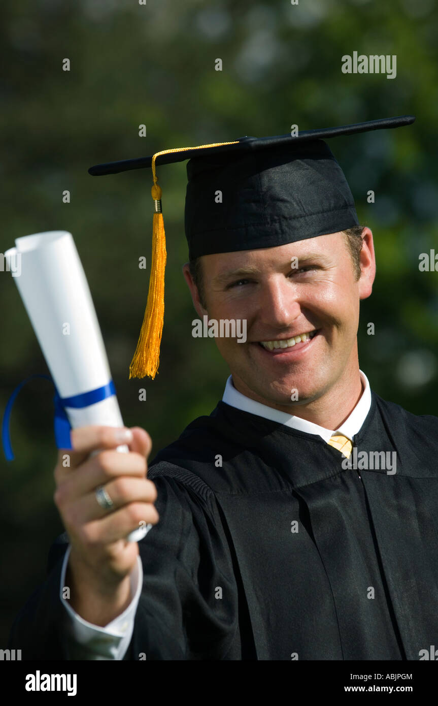 Male graduate holding diploma Stock Photo