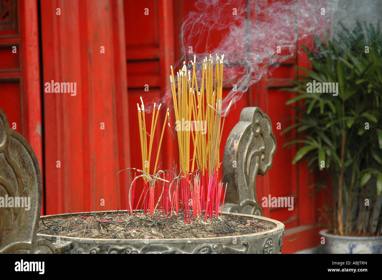 Burning incense sticks at Tran Quoc Pagoda in the centre of Hoan Kiem